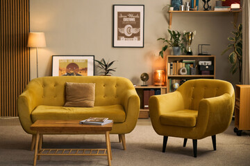 Modern living room interior featuring sofa, armchair, coffee table, framed wall art, creating home comfort concept. Suitable for furniture marketing, real estate, interior design © DragonImages