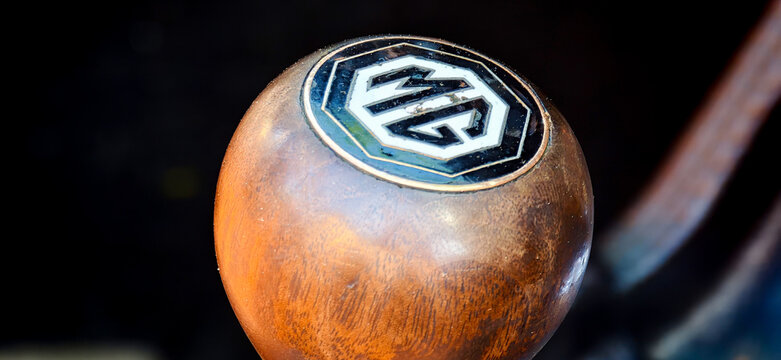 Saint Petersburg, Russia - May 23, 2026: MG car gear shift knob with wooden finish and logo, close-up view highlighting craftsmanship and automotive design details