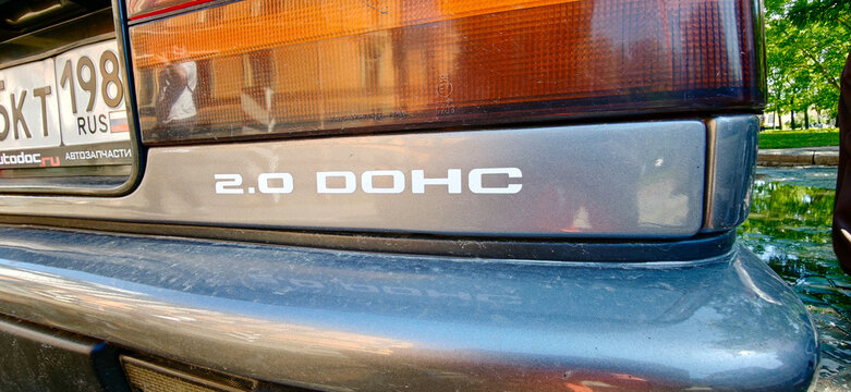 Saint Petersburg, Russia - May 23, 2026: Nissan Silvia 2.0 DOHC badge displayed on the rear of a gray car with a blurred green background of trees and sunlight