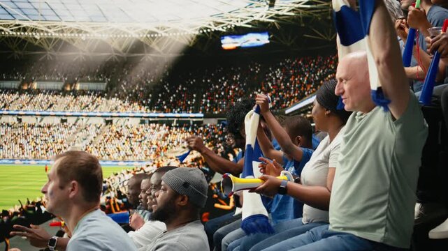 Excited young boy with scarf watching live soccer match with parent in packed stadium, surrounded by crowd energy and passionate supporters, black family cheering for national team, bonding.
