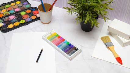 top view of pastels brushes and paper for creativity
