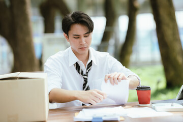 Fototapeta premium Frustrated unemployed professional tearing documents after job loss, expressing stress, career uncertainty, financial hardship, and the emotional impact of unemployment.