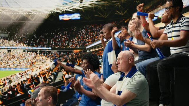 Happy soccer fans taking selfie with child during live match in crowded stadium stands, family outing during first match.