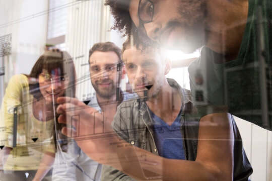Colleagues using transparent touchscreen display