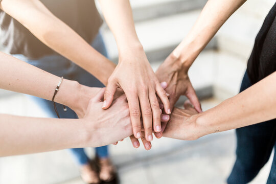 Close-up of three women stacking their hands