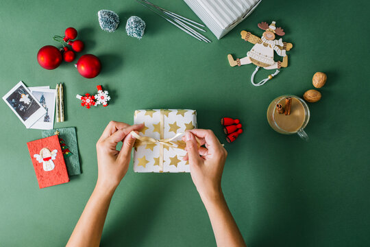 Woman's hands packing Christmas gift