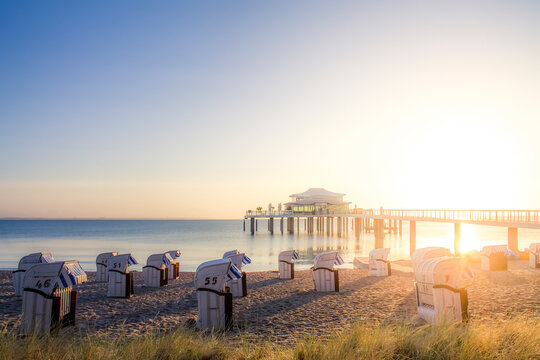 Germany, Niendorf, view to Timmendorfer Strand with hooded beach chairs and sea bridge