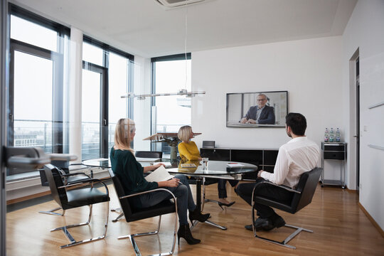 Business people having a video conference in board room