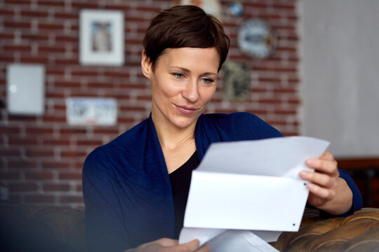 Woman reading letter at home