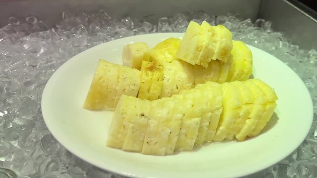 Video of fresh watermelon and pineapple slices served on ice with colorful tropical buffet style