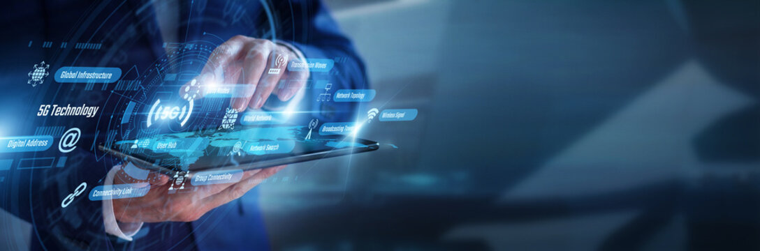 Telecom engineer working on tablet managing advanced 5G Technology network infrastructures. Futuristic hologram screen displaying fast digital communication data and global wireless signals.
