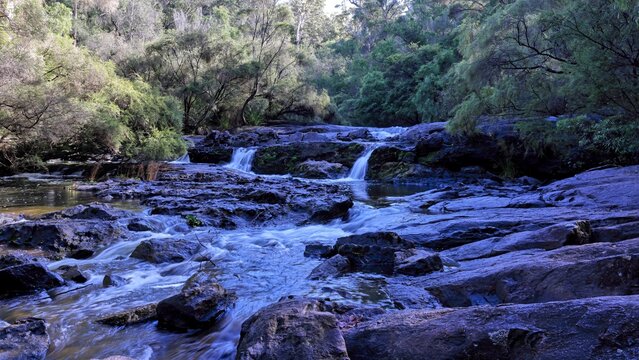 The Cascades, rapids. Lefroy Brook, Pemberton, South West Western Australia. Fast flowing, turbulent river. Rocks in foreground, Karri, Marri, and Jarrah forest background