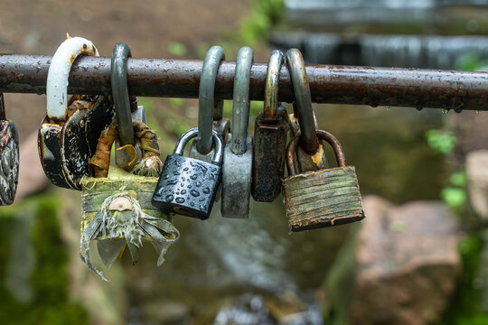 Wedding tradition padlocks on a railing in nature for marriage concept and holiday travel marketing. Metal locks on a bridge as a symbol of eternal love commitment loyalty and strong relationship bond