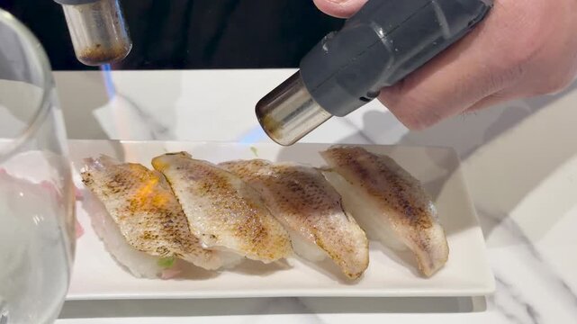 Chef Searing Fresh Nigiri Sushi With a Blowtorch in Kanazawa Japan