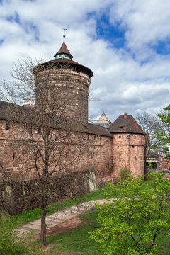 City walls of Nuremberg with Frauentorturm in Nuremberg, Germany. Exterior perspective of the historic tower under a cloudy sky
