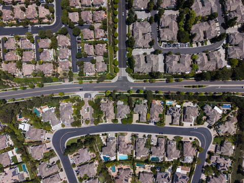 Top down aerial view of a suburban neighborhood and traffic intersection
