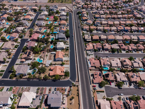 Top down aerial view of a desert suburban neighborhood with cul-de-sacs and pools