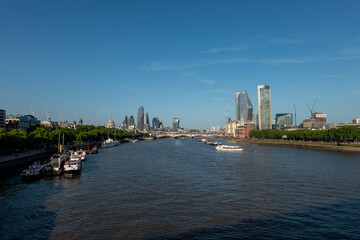 Obraz premium London, UK, 27th May 2026 - London Skyline from Waterloo bridge showing building work in progress and the main financial district, late evening suchine, wide angle