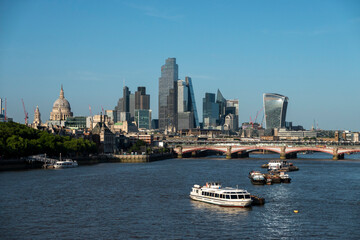 Obraz premium London, UK, 27th May 2026 - London Skyline from Waterloo bridge showing building work in progress and the main financial district, late evening suchine, tight shot with details of buildings