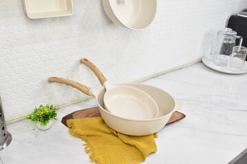 Premium Ceramic Pan with Kitchen Textile Styling, Premium ceramic pan styled with kitchen textile and herbs in contemporary kitchen environment for elegant cookware branding imagery. © Fikri