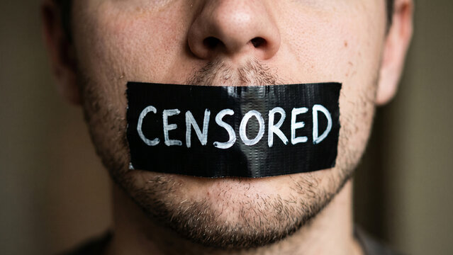 Close-up of tape on a human mouth with the word Censored, symbolizing the suppression of speech, silence, and social ostracism associated with mental health struggles and the advocacy for free speech