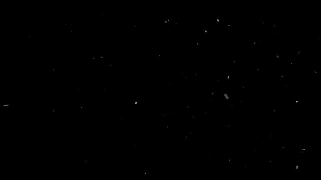 Vintage atmospheric dust particles gently float and drift randomly against a dark black background
