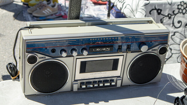 Polop, SPAIN - May 10, 2026.Vintage silver Crown Japan stereo cassette recorder and radio boombox for sale at flea market on a sunny day