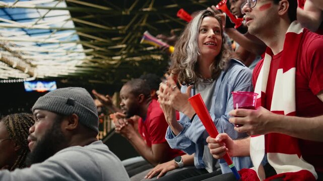 Woman football fan watching tense soccer match from stadium stands, emphasizing modern football and inclusion in sports, nervous supporters in the crowd react with silence and suspense.