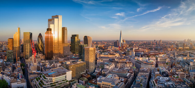 Panoramic view of the skyline of London, England, skyline from the City until Southbank with office skyscrapers reflecting the golden sunlight during sunset