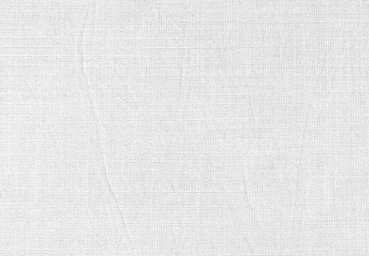 White fabric texture background with detailed fine woven linen canvas fiber and soft crumpled creased pattern for clean minimalist wallpaper mockup