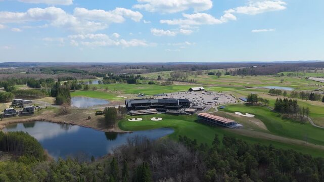 TPC Toronto Golf Course featuring the clubhouse, parking, and surrounding lakes. Ideal for real estate and travel promotions.