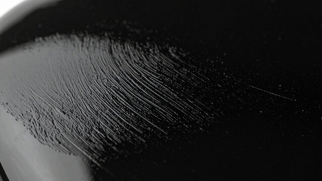 Fingerprint texture on glossy black Japanese lacquer surface, macro close-up

黒い漆塗りの表面に残る指紋のマクロ、光沢のある漆のテクスチャ