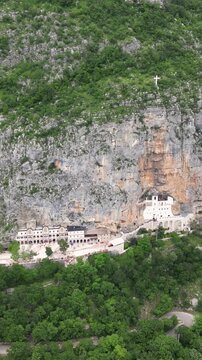 Aerial view of the Ostrog monastery built into a mountain cliff