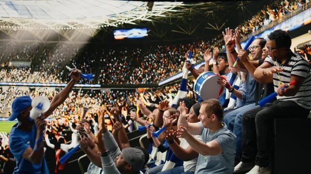 Passionate soccer supporter with megaphone leading stadium chant during football match in the crowded supporter section with supporter chants.