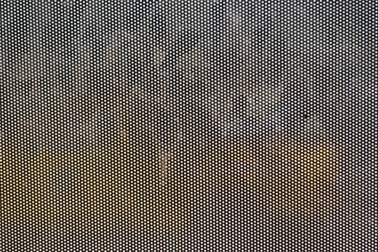 mesh texture with a regular geometric perforated pattern, often used in various industrial and commercial applications, suitable for technology or industrial themed designs.