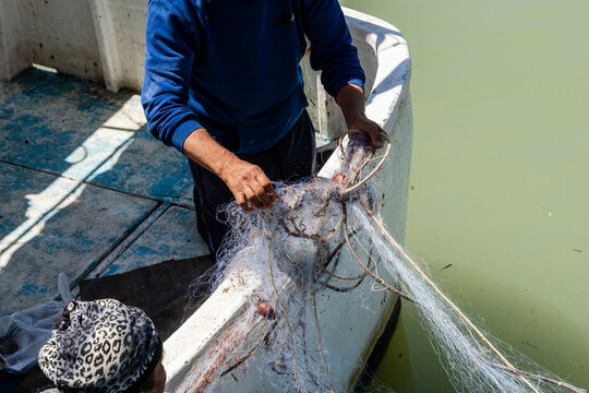 fishermen working, Mazara del Vallo , fishing port by the river,  Trapani, Sicily, Italy, Europe