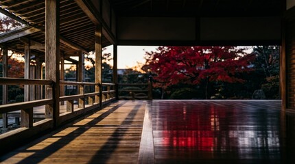 Fototapeta premium Serene Japanese Zen Garden Corridor with Fiery Red Autumn Maple Tree at Sunset
