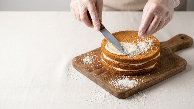 Baker Dusting Powdered Sugar On Layer Cake Close Up