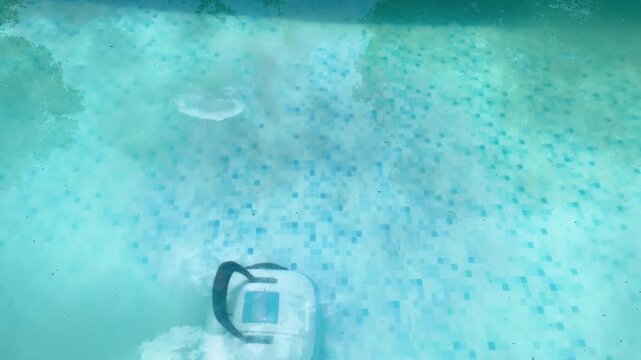close-up video of brandless robotic pool cleaner operating underwater,preparing swimming pool for summer season.concept of outdoor work efficiency, importance of cleanliness and hygiene during season