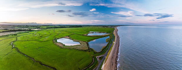 Fototapeta premium Marshes over Beach Rye Bay from a drone, Rye, East Sussex, England