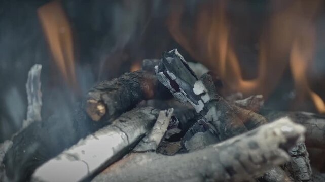 Cinematic close up of glowing barbecue embers and fire
