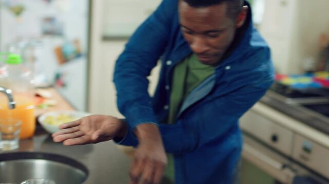 Dancing, cooking and black man with food in kitchen for lunch, meal prep and ingredients. Energy, happy and person with audio, playlist and music for groove, rhythm and movement with snack in home