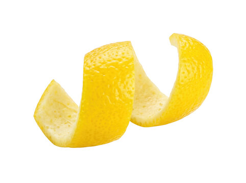 Lemon peel twist spiral isolated on black background for cocktail garnish