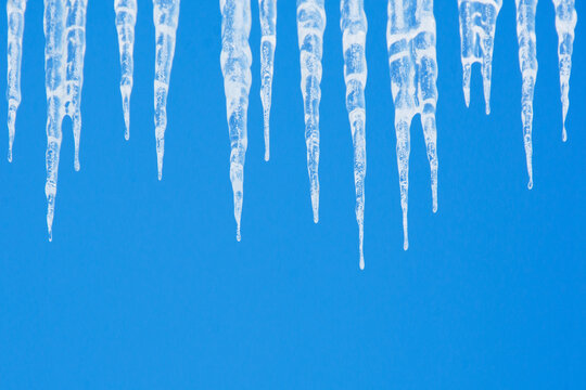 Icicles against clear blue sky