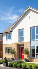 Fototapeta premium Modern Residential Home with Red Door and Landscaped Garden Under Blue Sky.