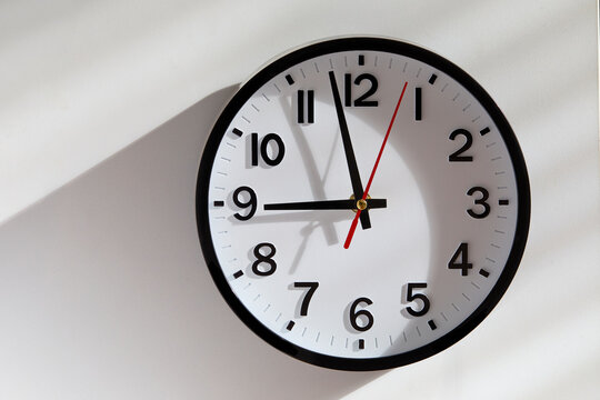 Wall clock with sunlight and shadow Background