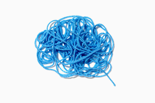 Tangled blue yarn on white background