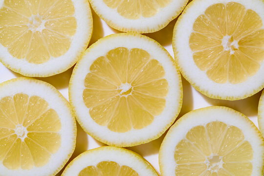 Close-up of sliced lemons on white background