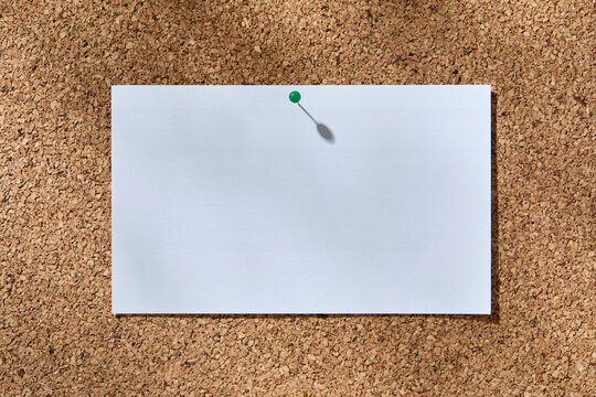 Blank white notecard on corkboard