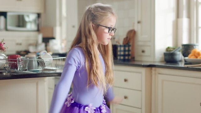 Child, home and dance with energy, ballet practice and creative performance with spin in kitchen. Girl, kid and moving as beginner ballerina in house, choreography and development with freedom